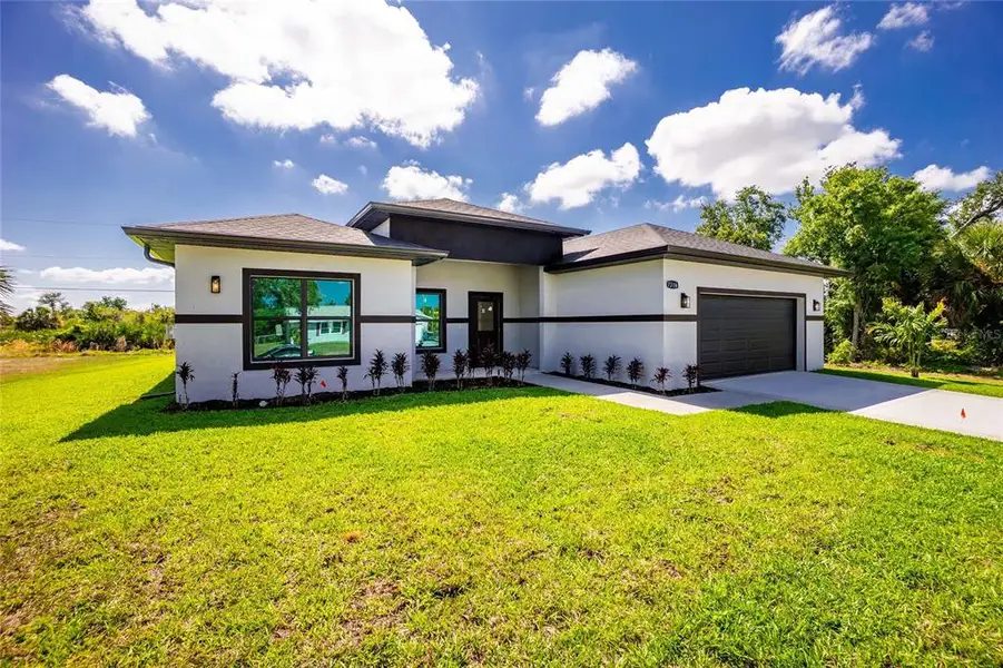 Front exterior of a new home in , Port Charlotte, FL, highlighting curb appeal (Image 27).