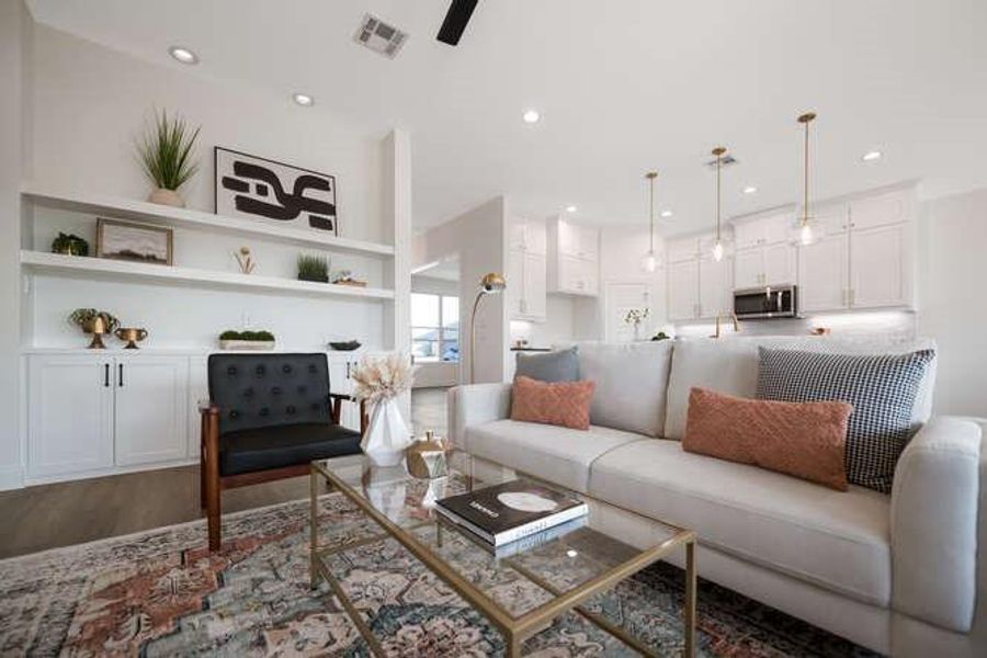 Living area with recessed lighting, wood finished floors, and a ceiling fan Living area with recessed lighting, wood finished floors, and a ceiling fan