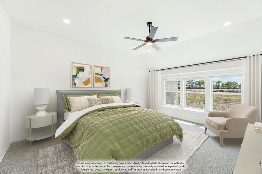 Bedroom with gray upholstered bed, green bedding, ceiling fan, and large window with outdoor view