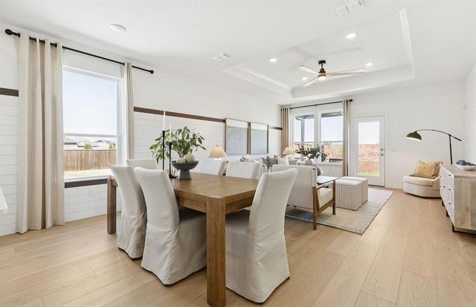 Formal dining room with large windows *Model Representation*