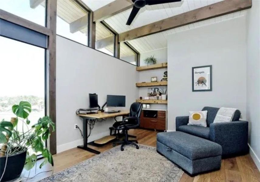 Office space with light wood finished floors and a ceiling fan Office space with light wood finished floors and a ceiling fan