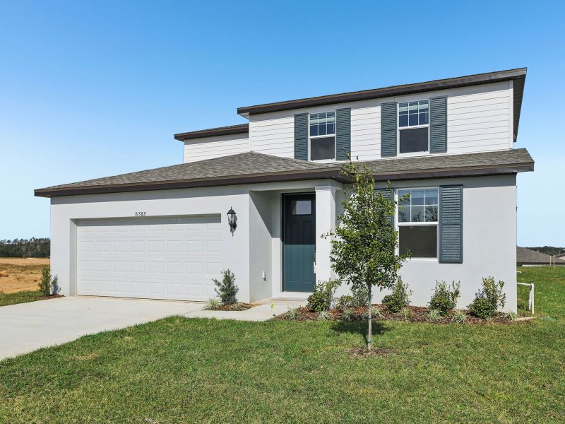 Front exterior of a new home in Benton Hills - Classic Series, Brooksville, FL, highlighting curb appeal (Image 2). Front exterior of a new home in Benton Hills - Classic Series, Brooksville, FL, highlighting curb appeal (Image 2).