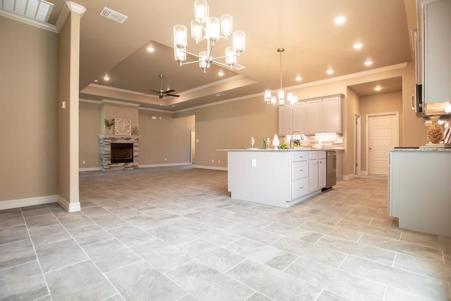 Kitchen with visible vents, a notable chandelier, ornamental molding, recessed lighting, and open floor plan