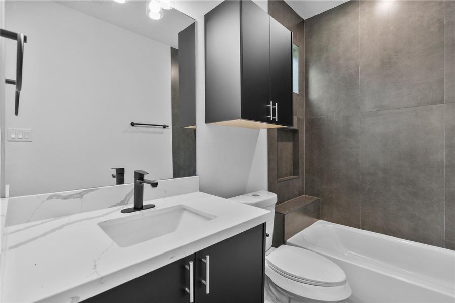 Designer first floor bath appointed with sleek matte-black fixtures, dramatic tilework and refined contemporary finishes Designer first floor bath appointed with sleek matte-black fixtures, dramatic tilework and refined contemporary finishes