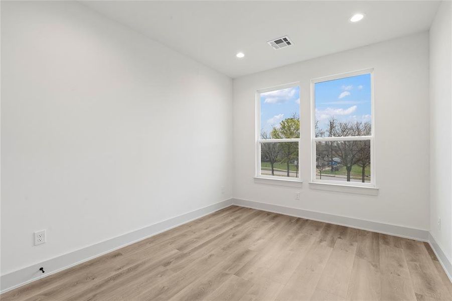 Well-appointed secondary bedrooms with high ceilings, large windows, and walk-in closets.