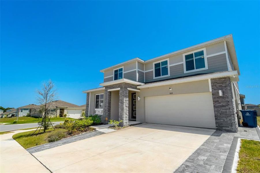 Front exterior of a new home in , Davenport, FL, highlighting curb appeal (Image 17). Front exterior of a new home in , Davenport, FL, highlighting curb appeal (Image 17).