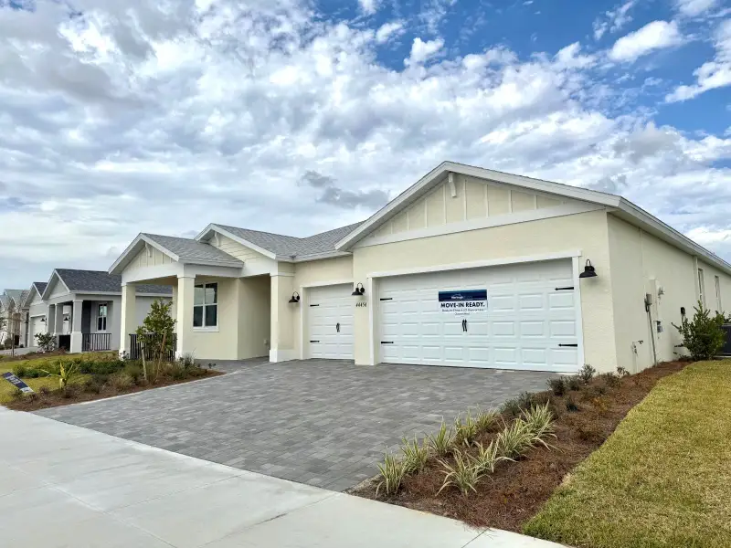 Front exterior of a new home in Crescent Lakes - Signature Series, Punta Gorda, FL, highlighting curb appeal (Image 8).