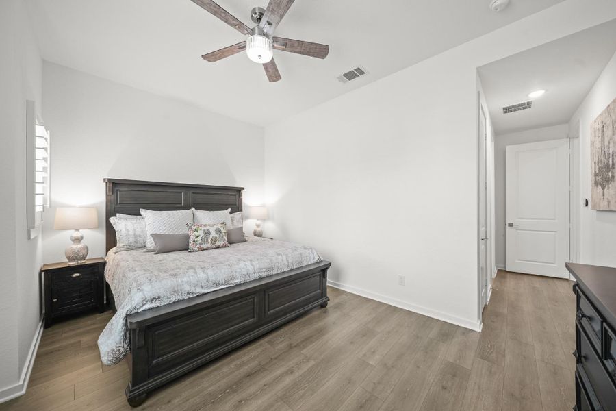 This second bedroom down is tucked away and includes an ensuite bath and closet perfect for overnight guests.Revwood flooring warms the space.