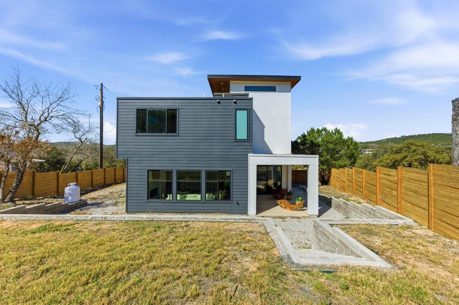 Back of property featuring a fenced backyard and a patio area