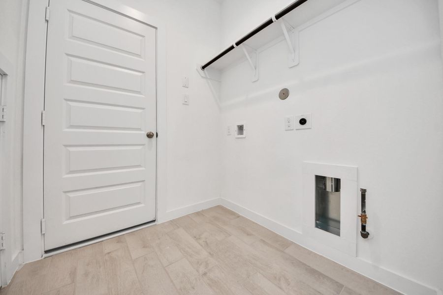 A perfect blend of functionality and comfort. Capture the essence of easy living with a first-floor laundry room, thoughtfully equipped with shelving for effortless organization. Both electric and gas connections available. A perfect blend of functionality and comfort. Capture the essence of easy living with a first-floor laundry room, thoughtfully equipped with shelving for effortless organization. Both electric and gas connections available.