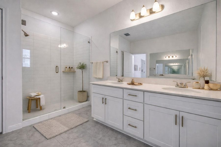 Bathroom with double vanity and a shower stall