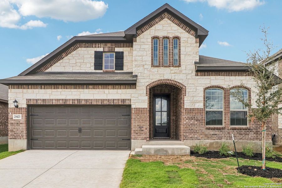 Front exterior of a new home in Fox Falls, Boerne, TX, highlighting curb appeal (Image 1).