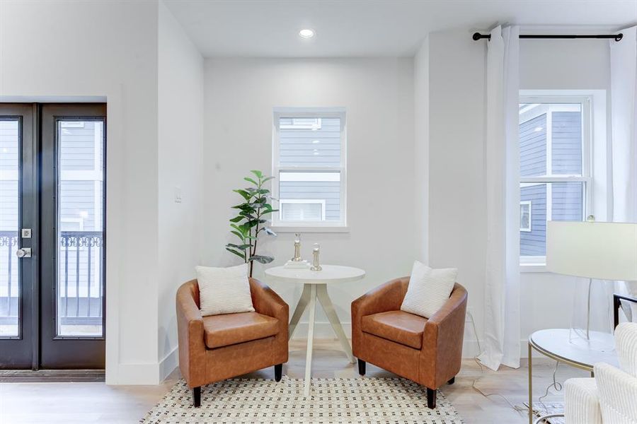 The flexible space on the side of the living room has its own special light and the doorway leads to the second floor balcony.