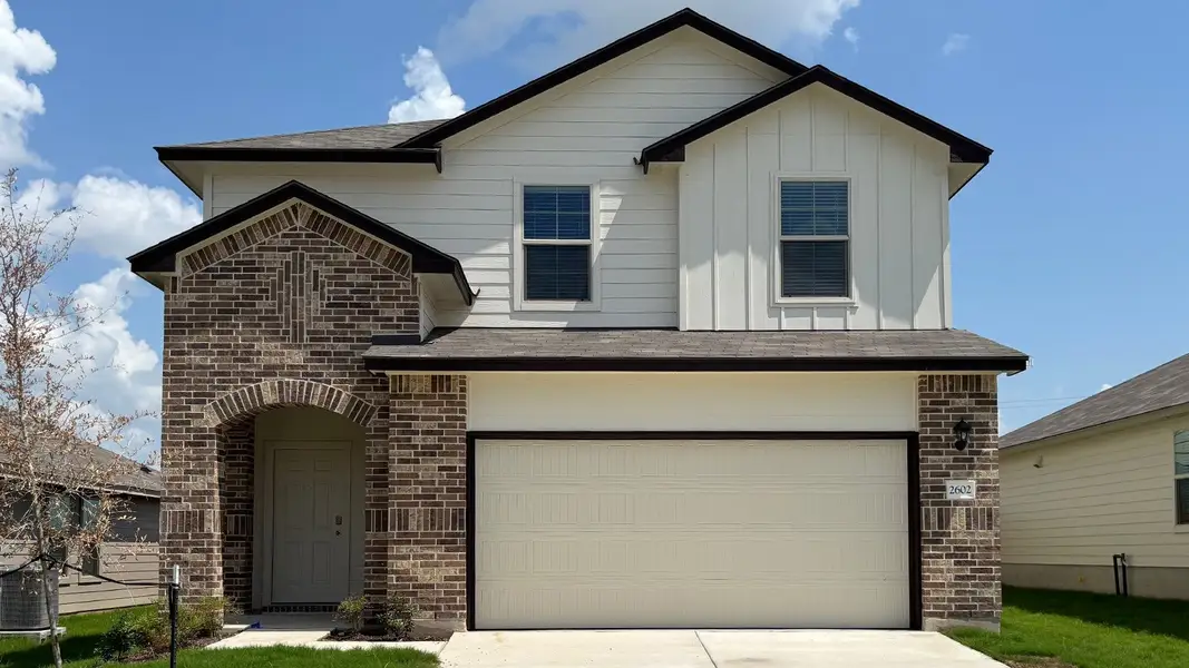 Front exterior of a new home in Pecan Creek, Temple, TX, highlighting curb appeal (Image 1).