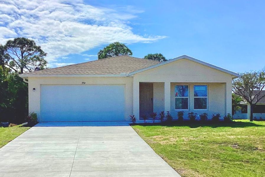 Front exterior of a new home in Cape Coral Classic, Cape Coral, FL, highlighting curb appeal (Image 1).
