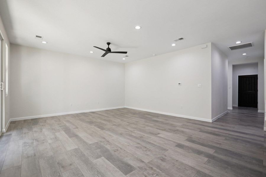 Spare room featuring a ceiling fan, recessed lighting, and light wood-type laminate flooring