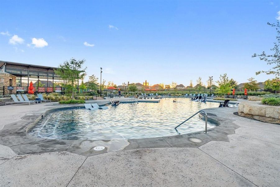 Community pool with a patio area Community pool with a patio area