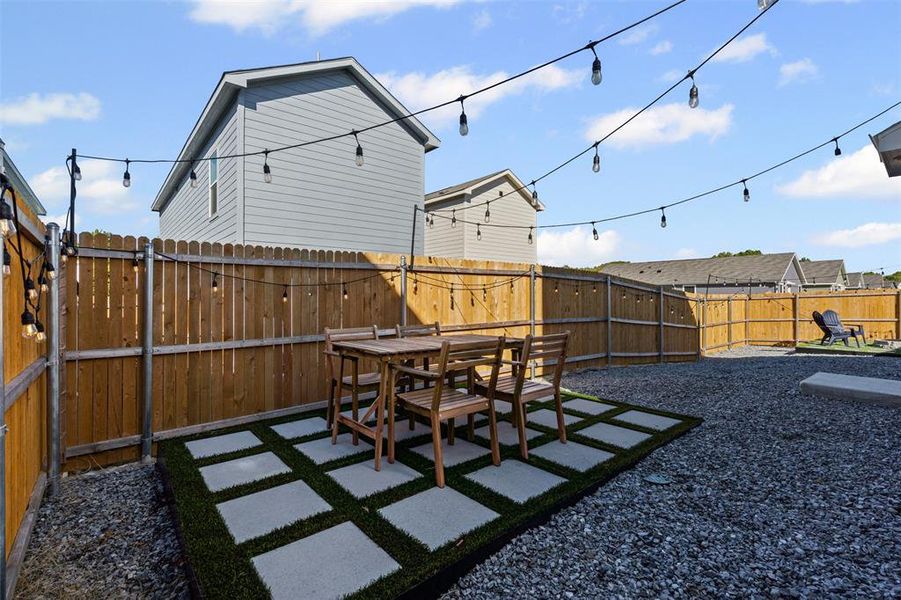 Fenced backyard featuring a patio area and outdoor dining space