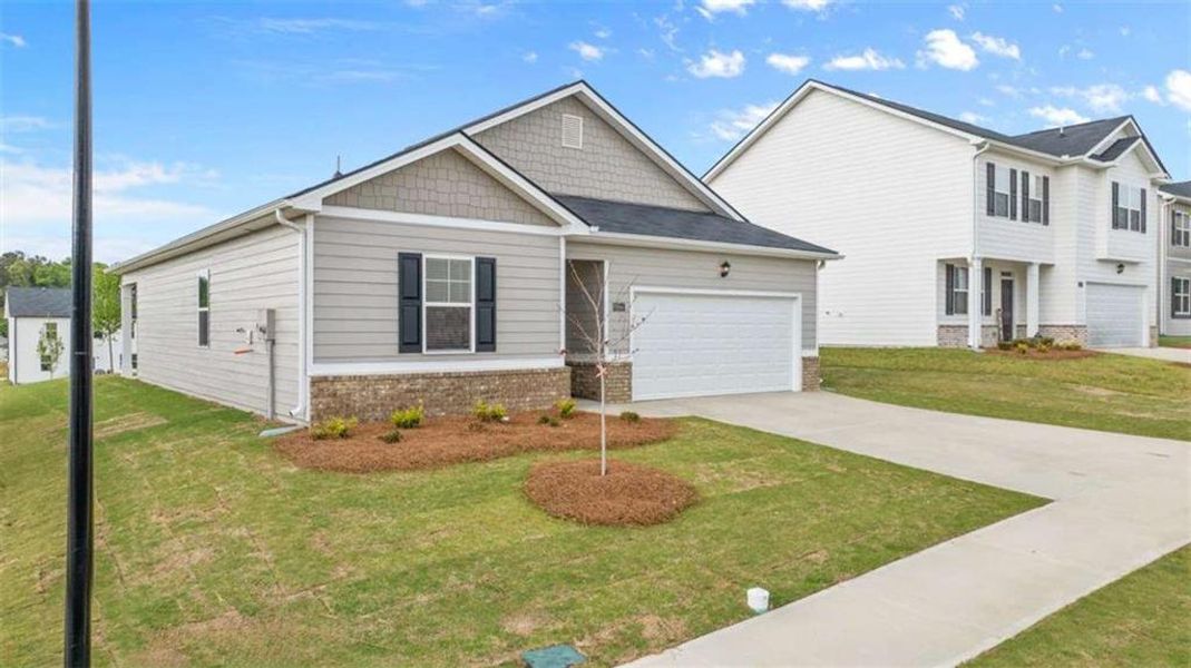 Front exterior of a new home in Champion's Run, Lithonia, GA, highlighting curb appeal (Image 20).