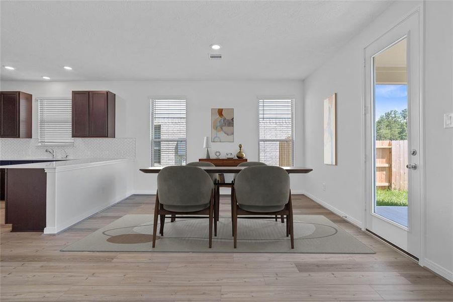 Make memories gathered around the table with your family and friends! This dining room features high ceilings, large windows, and easy access to your kitchen and living room.