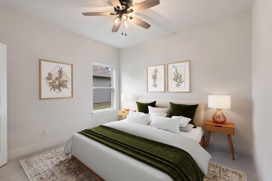 Carpeted bedroom featuring baseboards and ceiling fan