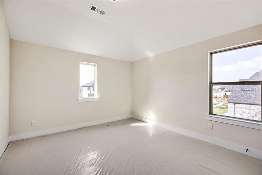 Spare room featuring baseboards and vaulted ceiling Spare room featuring baseboards and vaulted ceiling