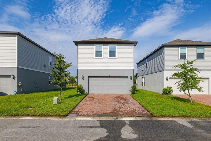 Front exterior of a new home in The Meadow at Crossprairie Bungalows, St. Cloud, FL, highlighting curb appeal (Image 1). Front exterior of a new home in The Meadow at Crossprairie Bungalows, St. Cloud, FL, highlighting curb appeal (Image 1).