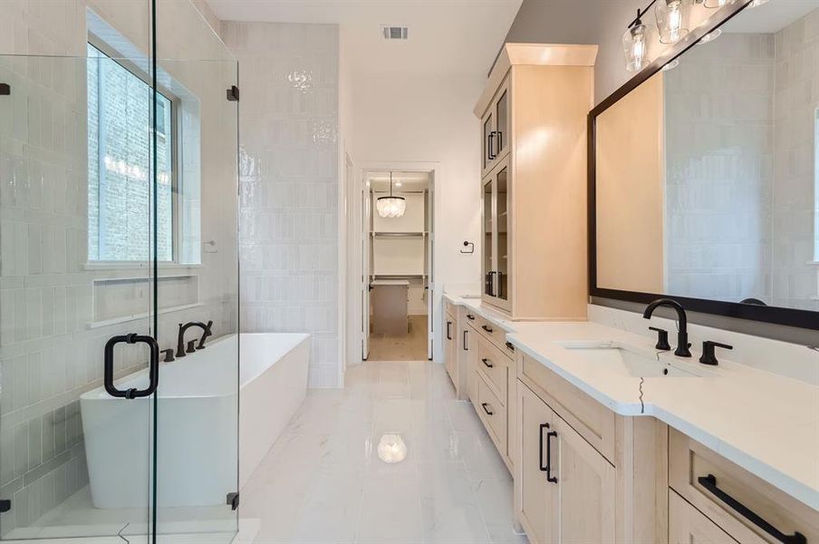 Bathroom featuring tile walls, independent shower and bath, and vanity