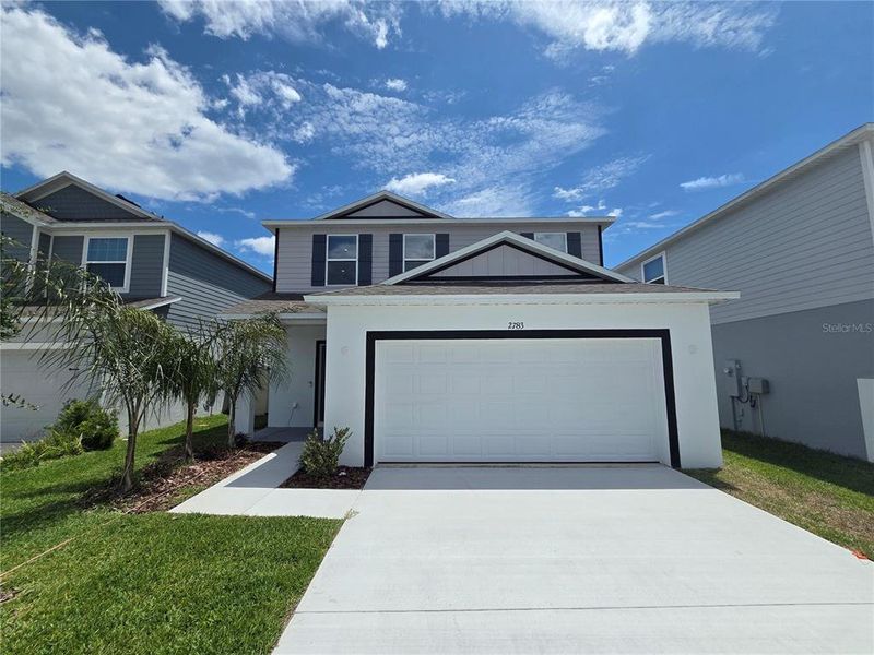 Front exterior of a new home in Villamar, Winter Haven, FL, highlighting curb appeal (Image 22).