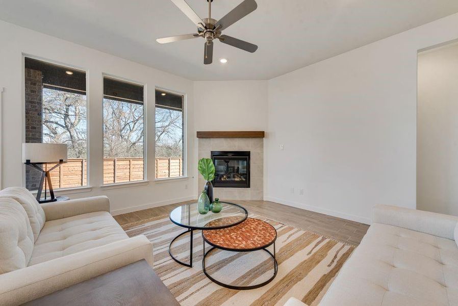 Living room featuring healthy amount of natural light, ceiling fan, light wood-type flooring, and recessed lighting