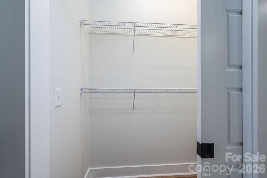 One of two walk-in closets for primary bedroom