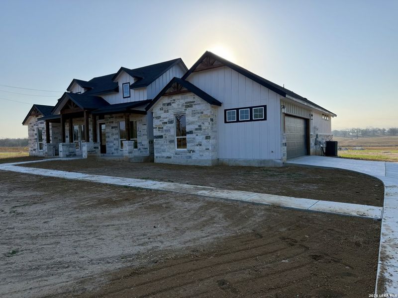 Front exterior of a new home in , Floresville, TX, highlighting curb appeal (Image 25).