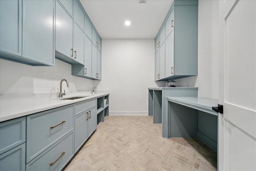 Laundry area with brick flooring and sink