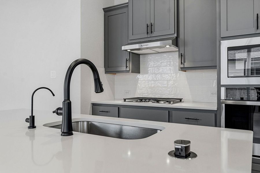 A well-appointed kitchen showcasing elegant cabinetry and contemporary appliances.