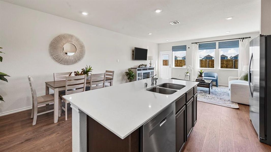 Kitchen with open floor plan, appliances with stainless steel finishes, dark wood finished floors, a kitchen island with sink, and recessed lighting