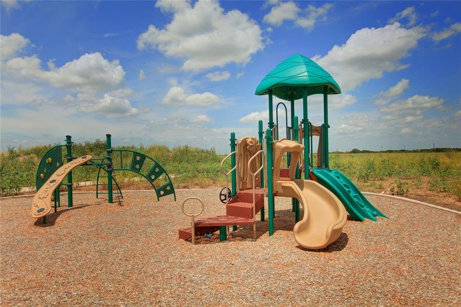 Outdoor playground featuring multiple slides, climbing structures, a covered tower, and soft ground cover