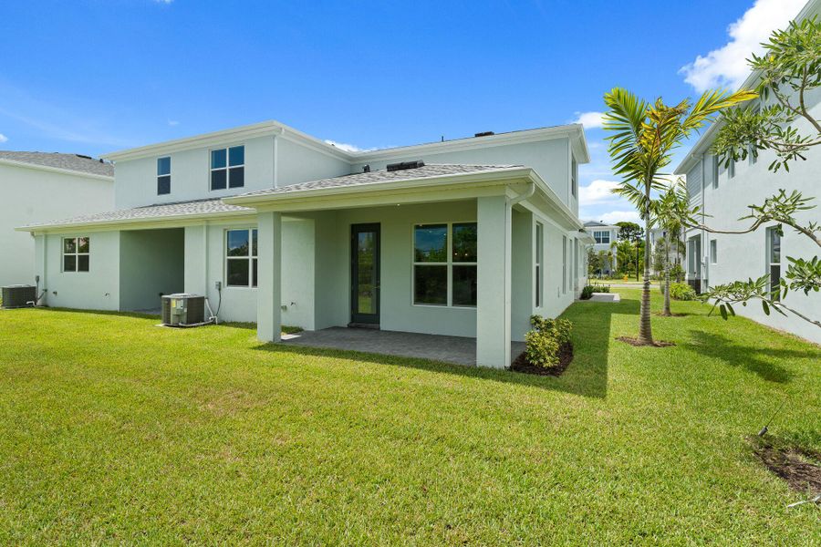 Front exterior of a new home in Avila, Jensen Beach, FL, highlighting curb appeal (Image 2).