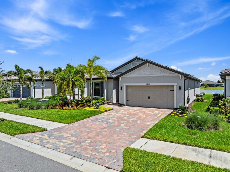 Front exterior of a new home in Del Webb Naples, Ave Maria, FL, highlighting curb appeal (Image 19).