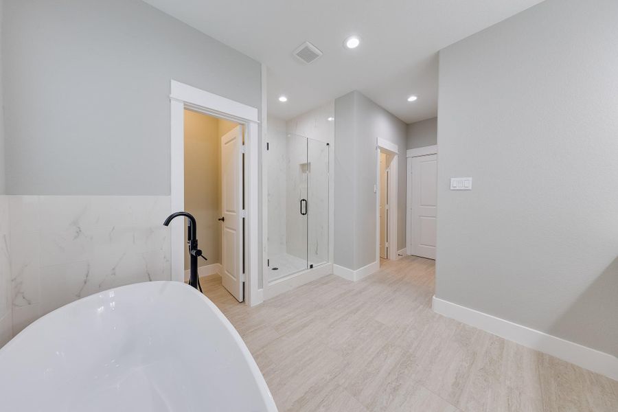 Primary bath with a private toilet area, ensuring added privacy and convenience for a comfortable experience. Primary bath with a private toilet area, ensuring added privacy and convenience for a comfortable experience.