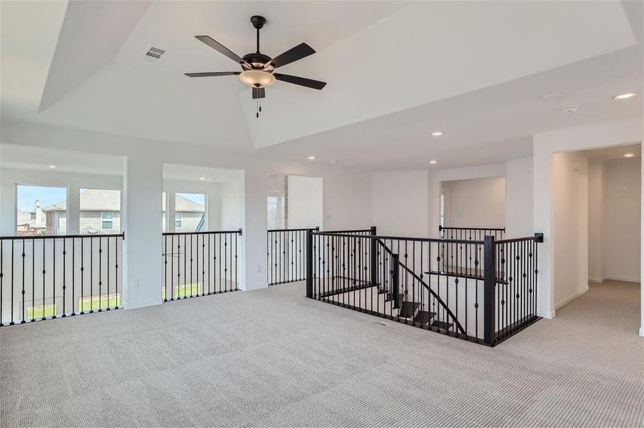 Spare room with light carpet and ceiling fan