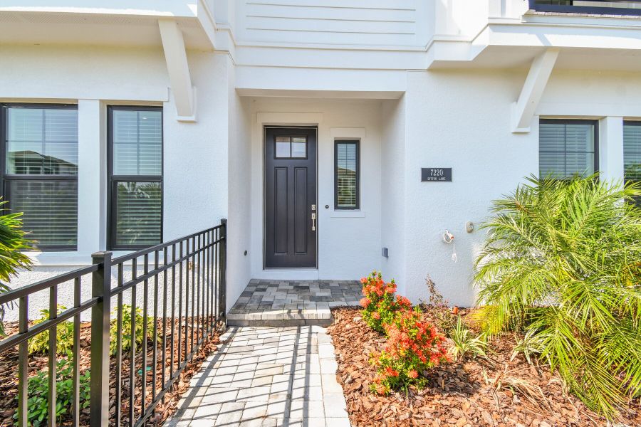 Exterior details and patio area of a home in Emerald Landing at Waterside at Lakewood Ranch – City Homes, Sarasota (Image 24).