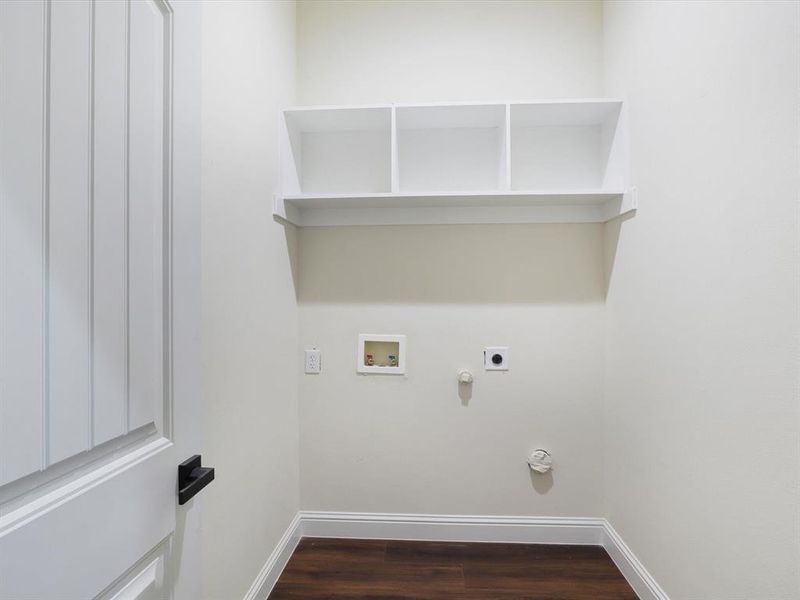 Laundry area with dark wood-style flooring, washer hookup, hookup for an electric dryer, and gas dryer hookup Laundry area with dark wood-style flooring, washer hookup, hookup for an electric dryer, and gas dryer hookup