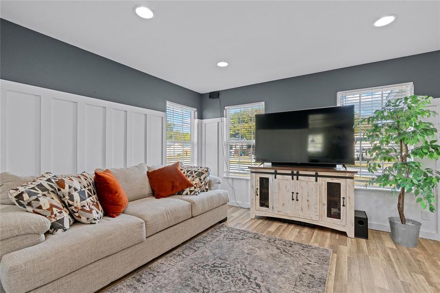 Living room featuring light hardwood / wood-style floors and a healthy amount of sunlight