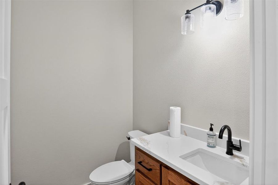 Half Bathroom vanity featuring a rectangular undermount sink and a white countertop Half Bathroom vanity featuring a rectangular undermount sink and a white countertop