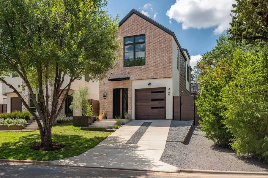 Modern architectural lines define this brick and stucco exterior featuring an integrated garage. Modern architectural lines define this brick and stucco exterior featuring an integrated garage.