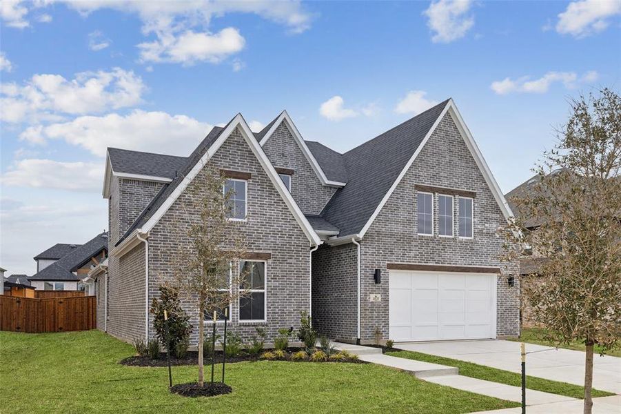 Elegant brick featuring cedar headers and striking trim create the ultimate curb appeal for this beautiful dream home!