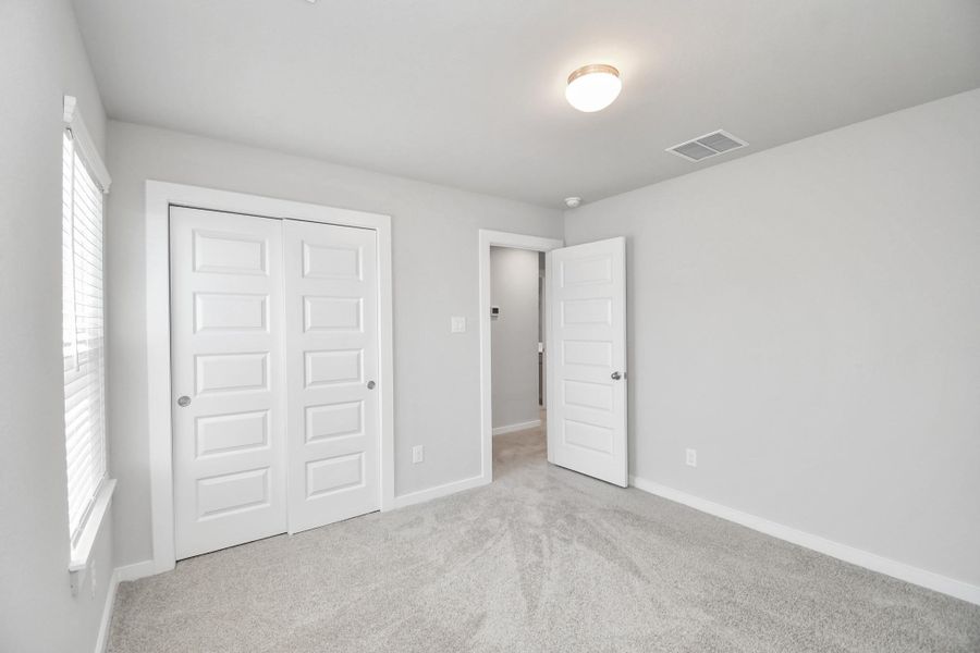 Secondary bedroom features plush carpeting, large windows that let in plenty of natural light, bright paint, and spacious closets. Secondary bedroom features plush carpeting, large windows that let in plenty of natural light, bright paint, and spacious closets.