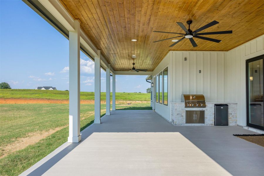 View of patio / terrace with an outdoor kitchen and a ceiling fan. Outdoor speakers