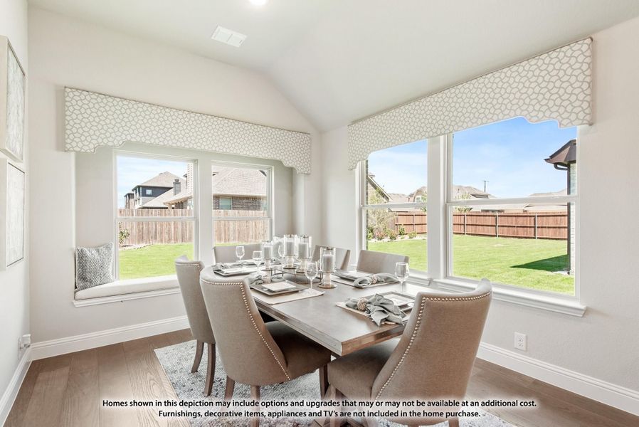 Dining room with six-chair table, vaulted ceiling, large windows, and hardwood floors overlooking backyard Dining room with six-chair table, vaulted ceiling, large windows, and hardwood floors overlooking backyard