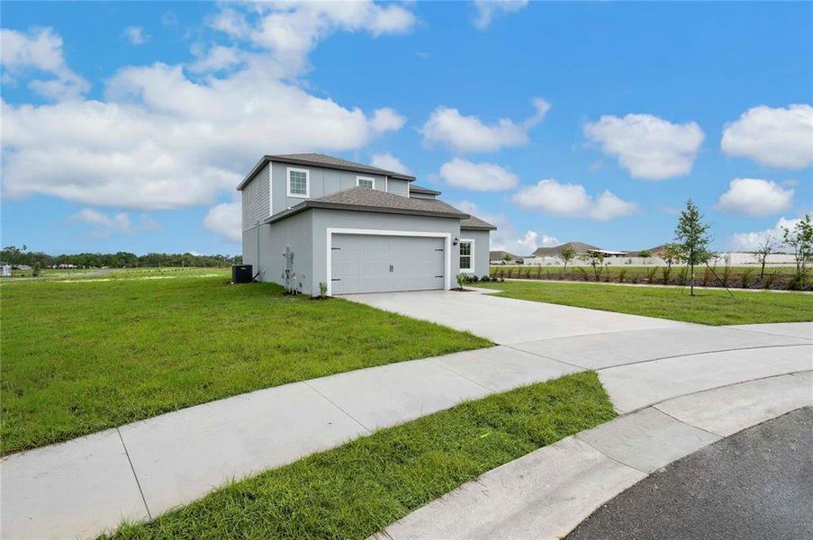 Front exterior of a new home in Citrus Place, Babson Park, FL, highlighting curb appeal (Image 17).